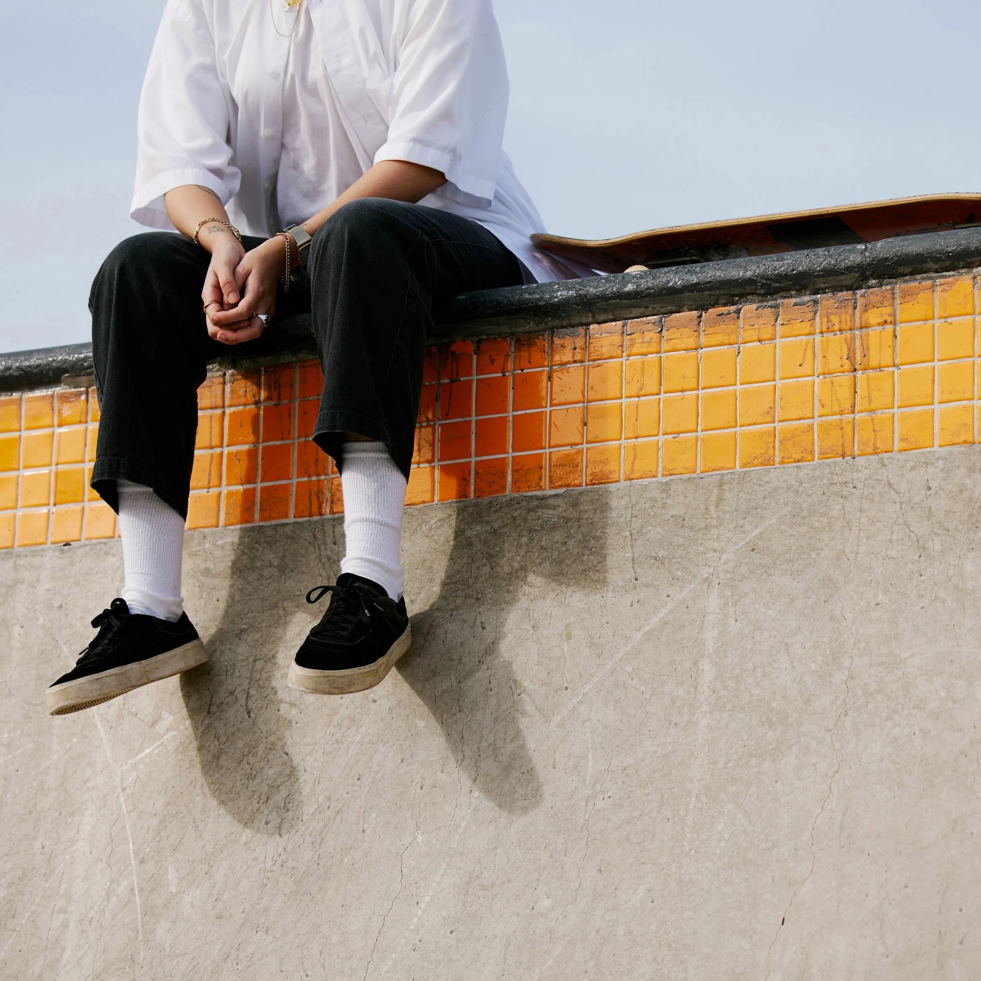 Guy on a wall with his skateboard