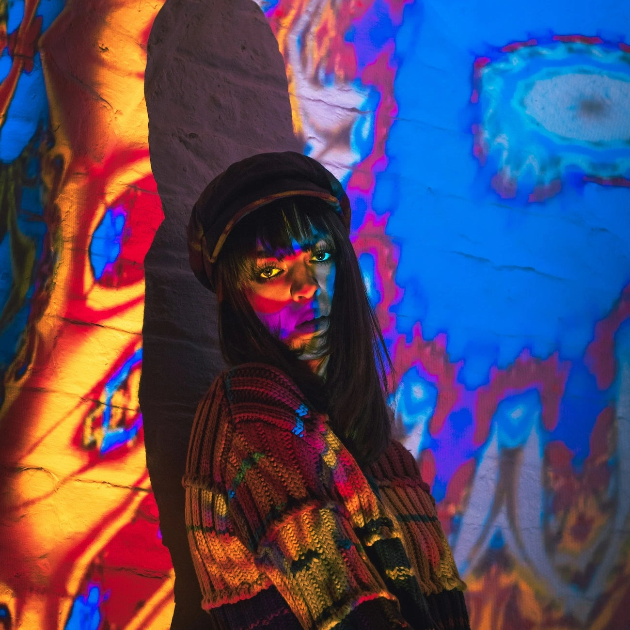 Woman in front of a colored wall